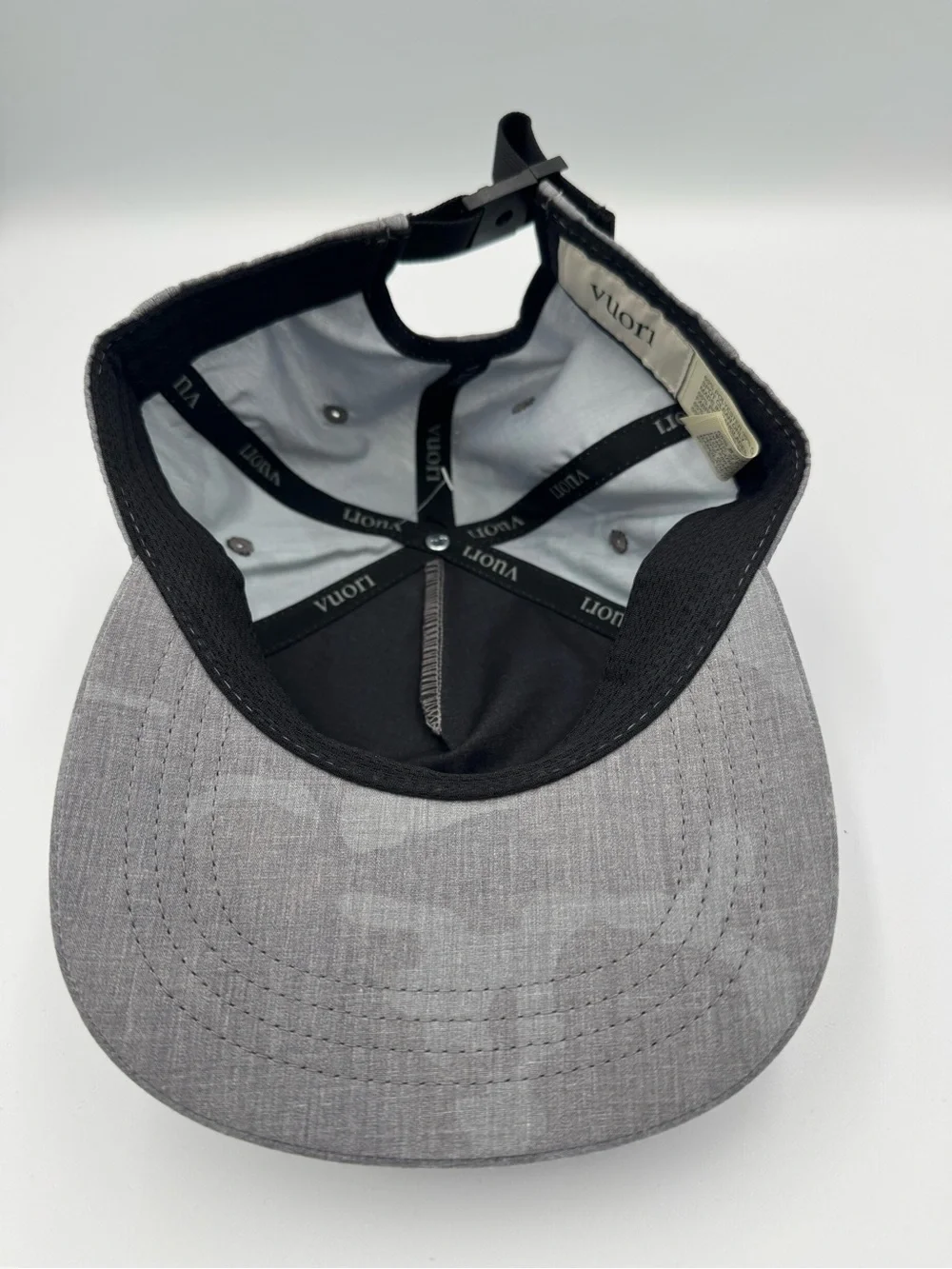 Vuori Gray Five-Panel Adjustable Cap/ Front Patch with faint camo design on brim